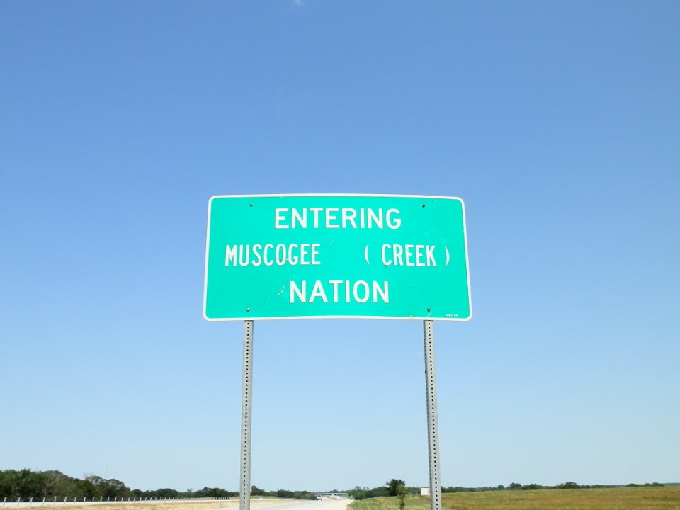 Road sign reading "Entering Muscogee (Creek) Nation"